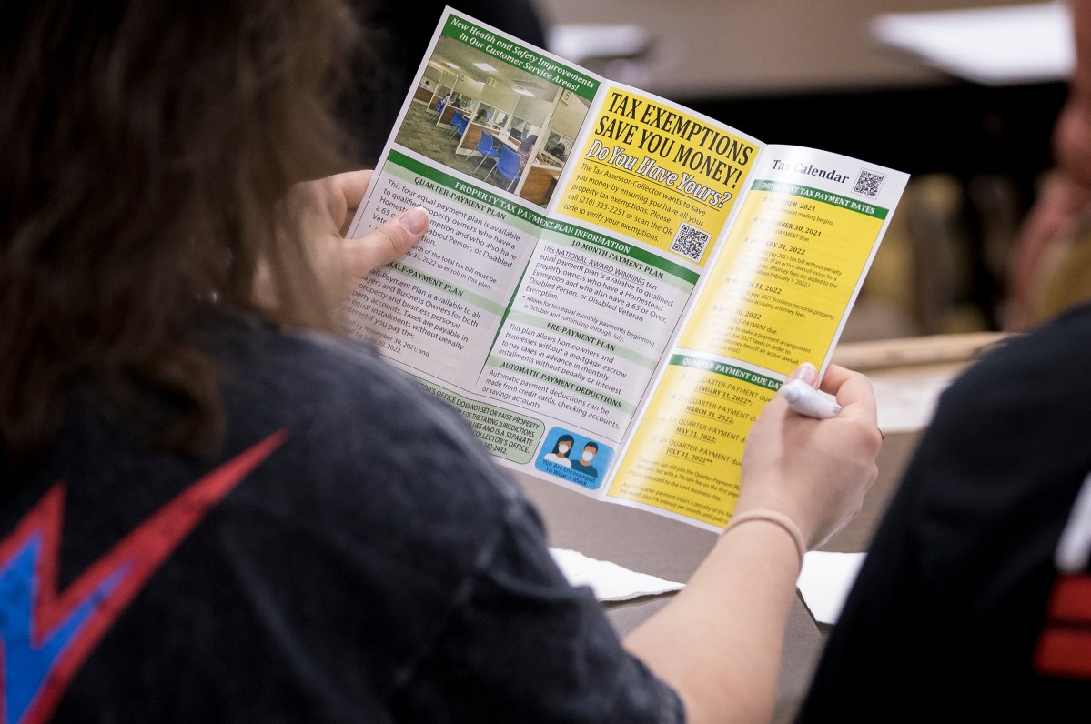 A homeowner reads an informational pamphlet during a property tax workshop on Saturday.