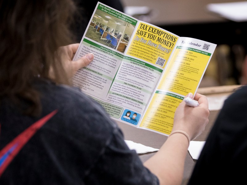 A homeowner reads an informational pamphlet during a property tax workshop on Saturday.