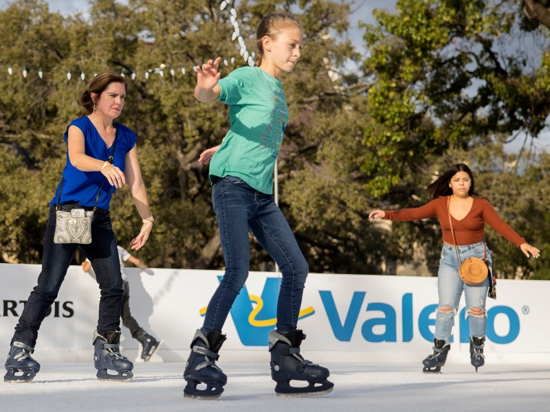 People skate on at the Rotary Club’s ice rink at Travis Park on Sunday.