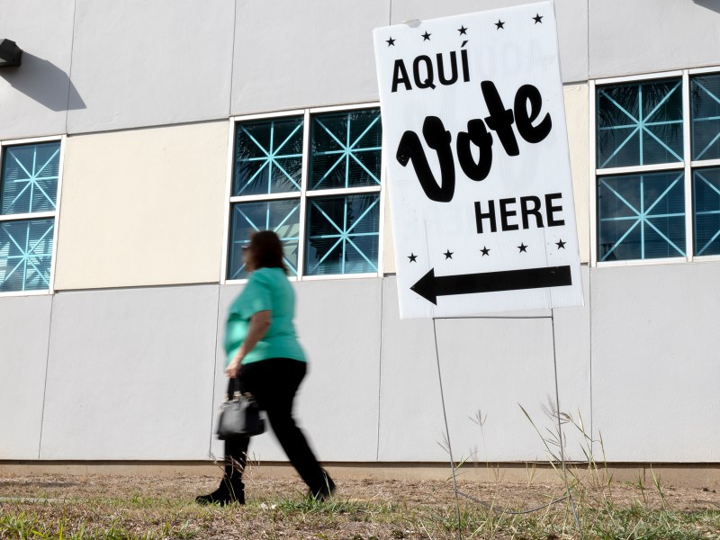 A woman walks to the Las Palmas Library to cast her ballot in the 2022 midterm elections on Tuesday.