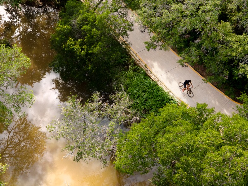 A bicyclist rides on the Salado Creek Greenway trail in 2021.