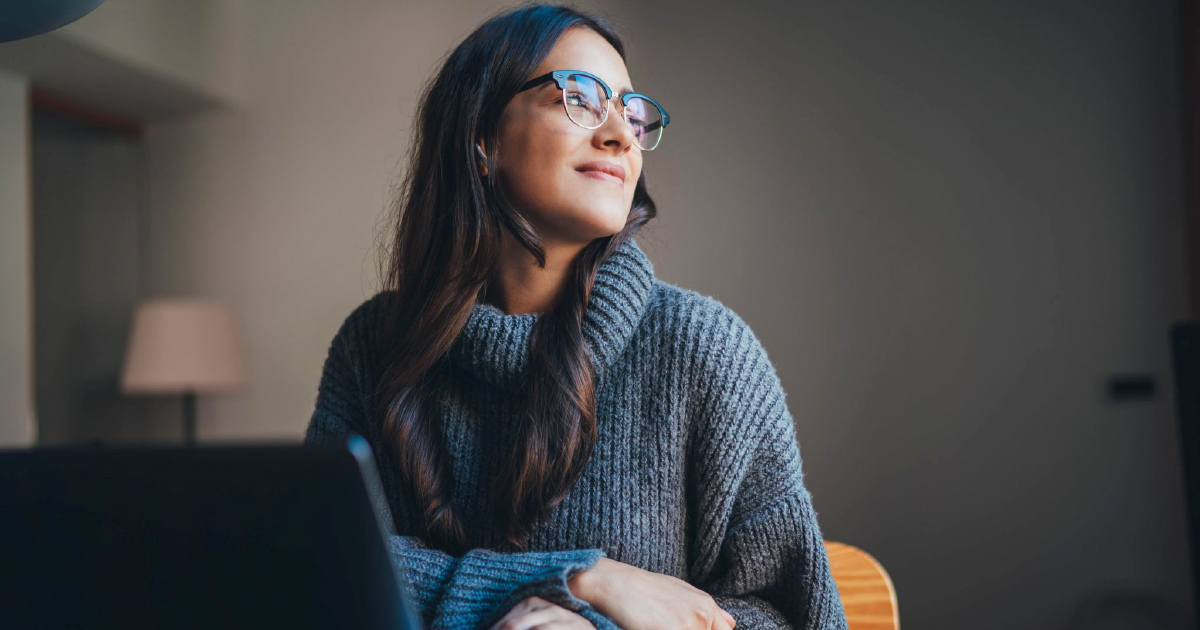 Person smiles while looking to the side