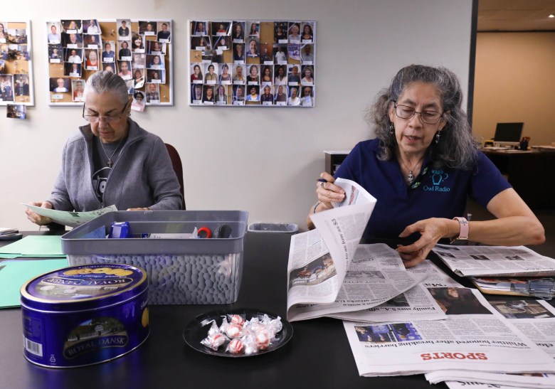 Volunteers Laura Rodriguez, left, and Veronica Salinas prepare for the upcoming live reading of the San Antonio Express News at the Owl Radio studio.