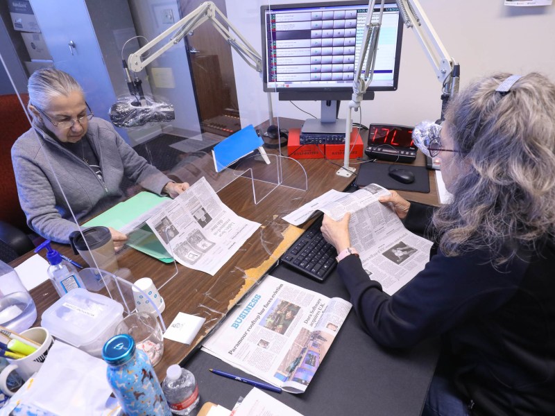 Volunteers Veronica Salinas, left, and Laura Rodriguez read news stories from the San Antonio Express News as part of Owl Radio which aids the visually impaired with audible daily news offerings.