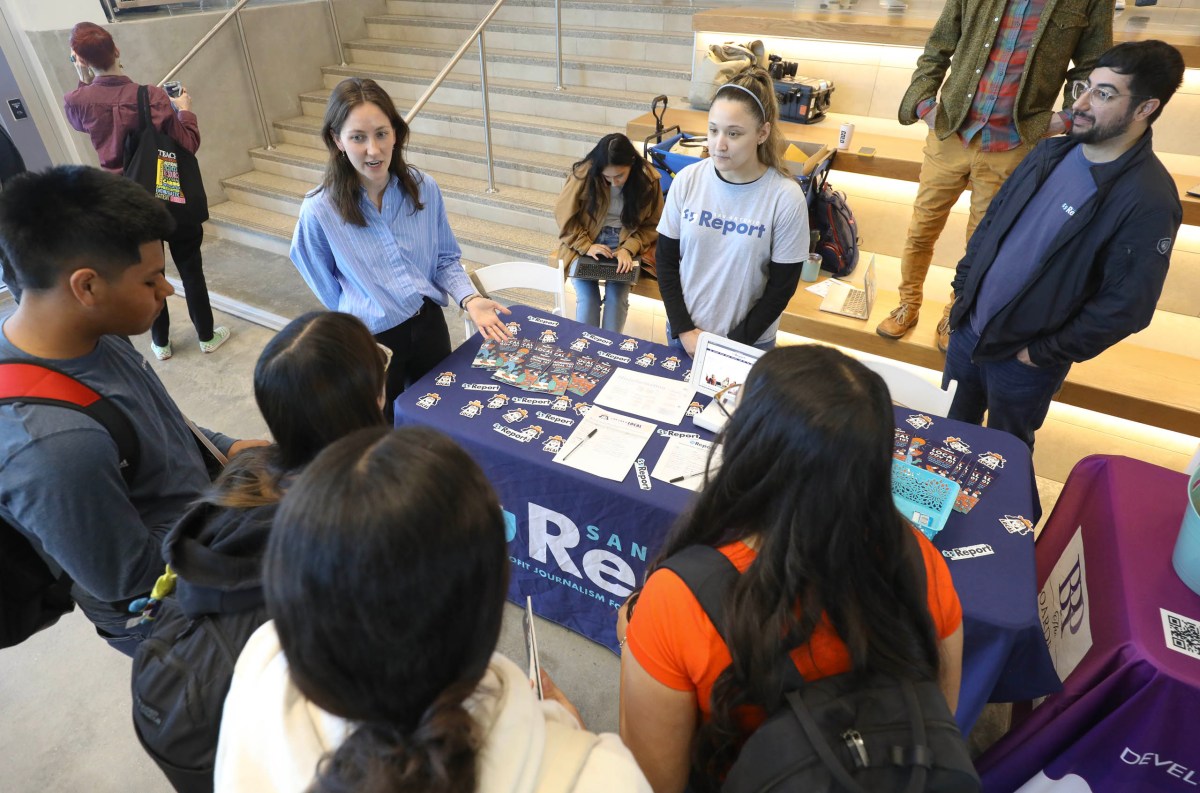 Staff members of the San Antonio Report speak with students during Youth Do Vote's Youth Voter (and Poll Worker) Fest at Palo Alto College on Tuesday.