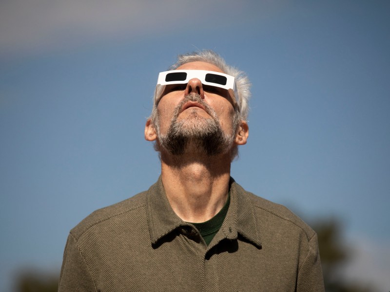 Visitors at Scobee Education Center and Planetarium gaze towards the sun and moon during the moment of annularity of the 2023 eclipse.