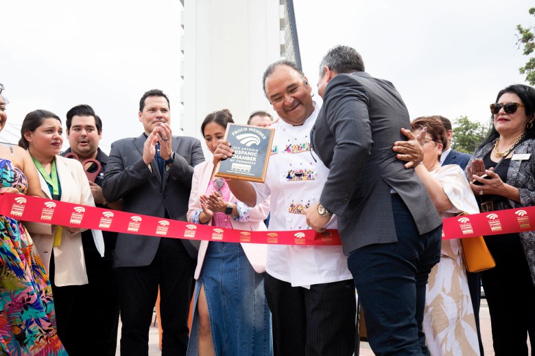 Chef John Hernandez, center, is given a plaque from the San Antonio Hispanic Chamber of Commerce celebrating the opening of Maverick Coffee Bar at La Villita.