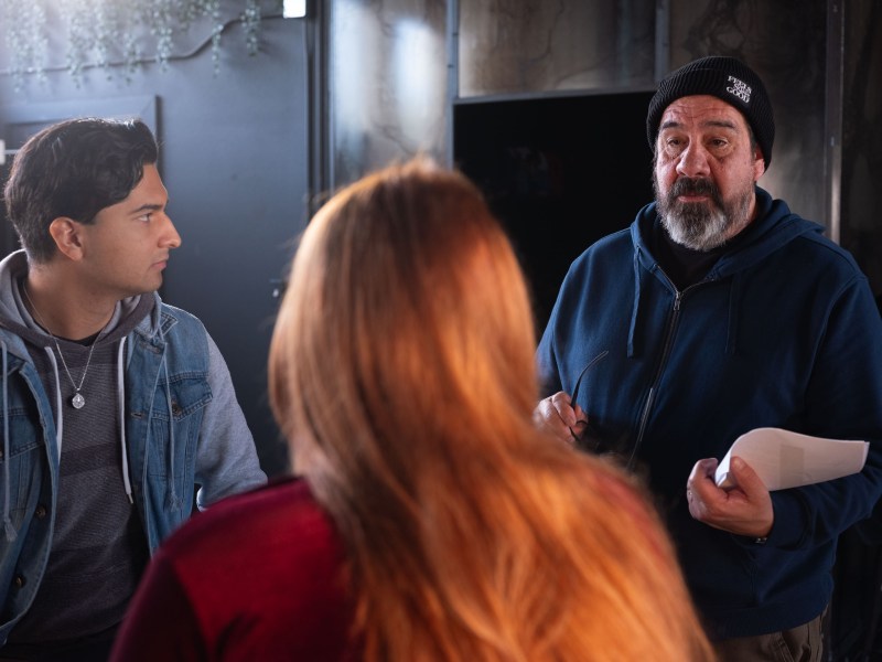 Ernest Hernandez, professor and director of video production, right, works with UTSA Film and Media Studies students on a scene of The Compass, at Graves Coffee Shop in January.