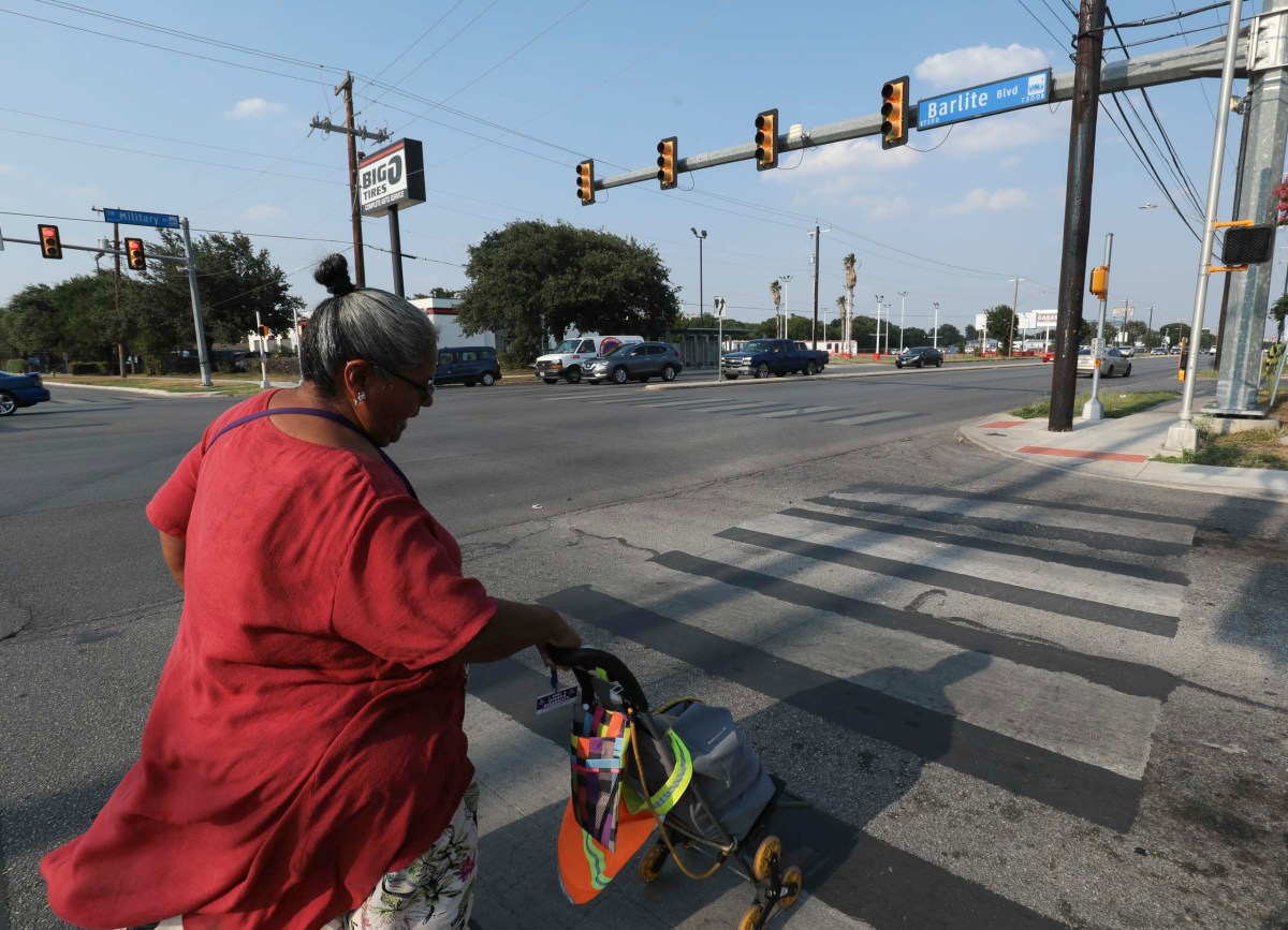 Margarita Rubio crosses an intersection to reach her fifth ride with VIA in less than two hours.