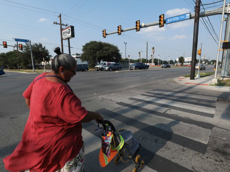 Margarita Rubio crosses an intersection to reach her fifth ride with VIA in less than two hours.