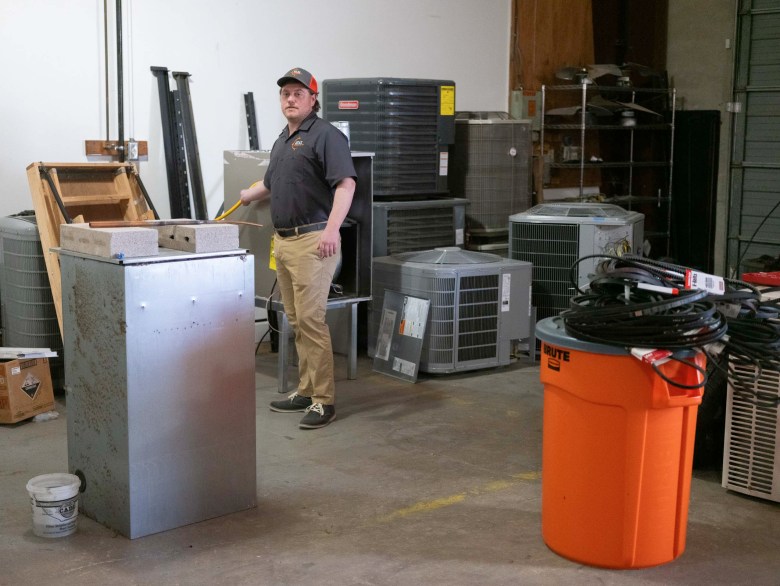 Kenneth Thompson demonstrates a variety of HVAC components set aside for future training purposes. 