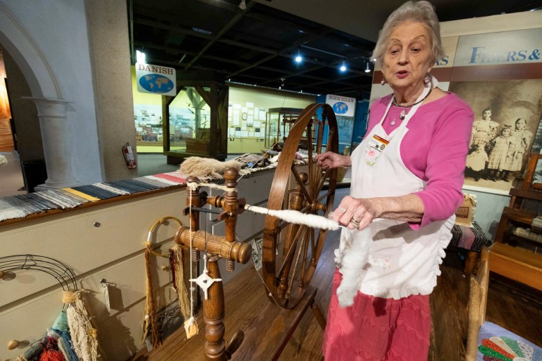 Betty Kitchens has been a docent at the Institute of Texan Cultures for over 25 years. Here Kitchens spins cotton into thread using a spindle.