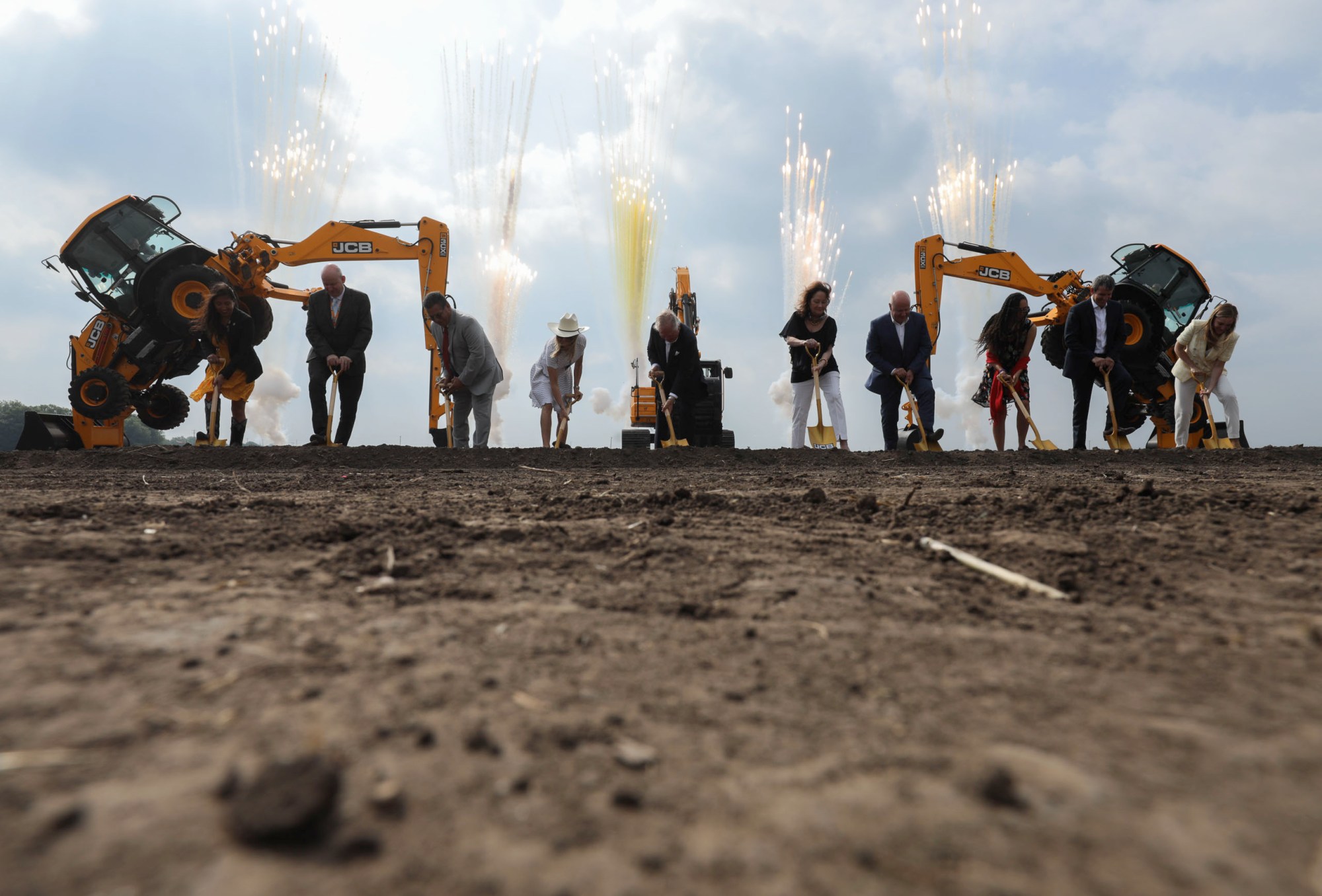 JCB family and employees along with local officials use golden shovels to officially break ground on the future manufacturing facility for construction equipment.