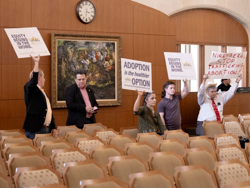 Pro life protestors hold up signs in support of their cause during a presentation to San Antonio City Council on recommended funding for the $500,000 reproductive justice budget item.