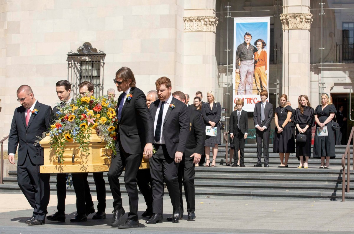 Pallbearers carry Billy Joe "Red" McCombs' casket out of the Tobin Center for the Performing Arts following a memorial service as other family members watch Monday.