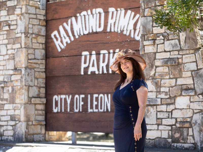 Linda Brewster stands in front of the Raymond Rimkus Park sign in Leon Valley.