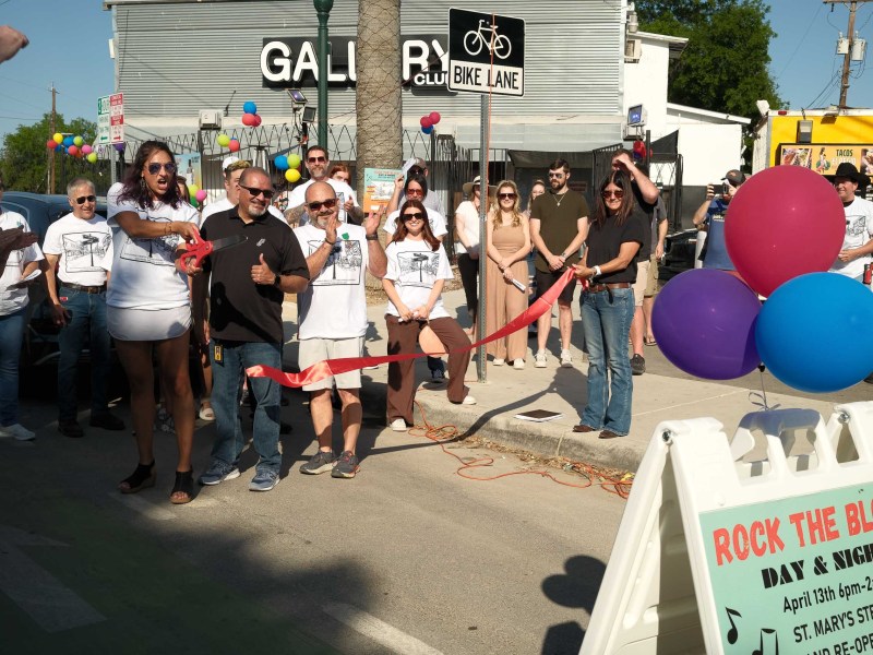 Councilwoman Sukh Kaur (D1) cuts a ribbon alongside businesses and neighbors on the Saint Mary's Strip celebrating the completion of construction on the popular entertainment district.