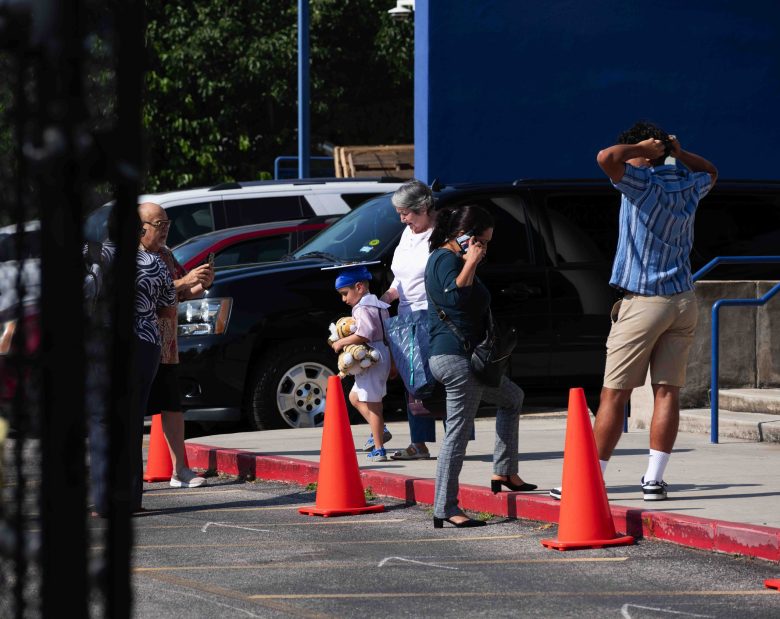 Asher, 5, leaves Gonzales  Early Childhood Center with his family following his Pre-K graduation. 