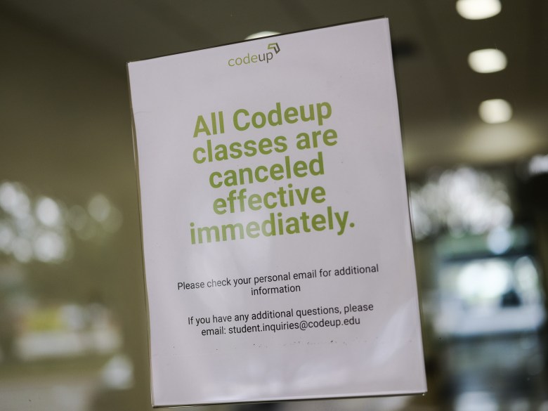 A sign at the front door of the office building where Codeup was operating informs students of the cancellation. 