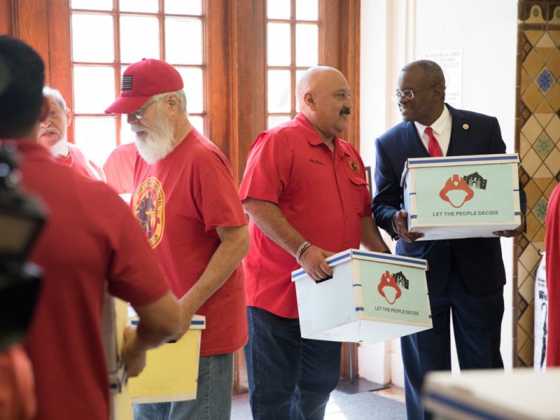 San Antonio Professional Firefighter Union President Chris Steele (right) delivers petitions to City Hall.