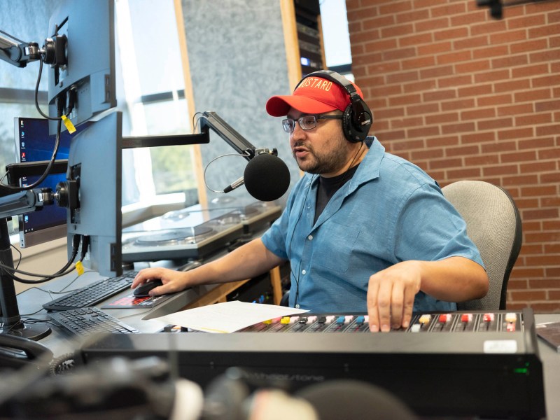 James Velten known as 'Hot Mustard' on his weekday morning show 'The Sauce' speaks with listeners from the newly renovated KSYM studios at San Antonio College.