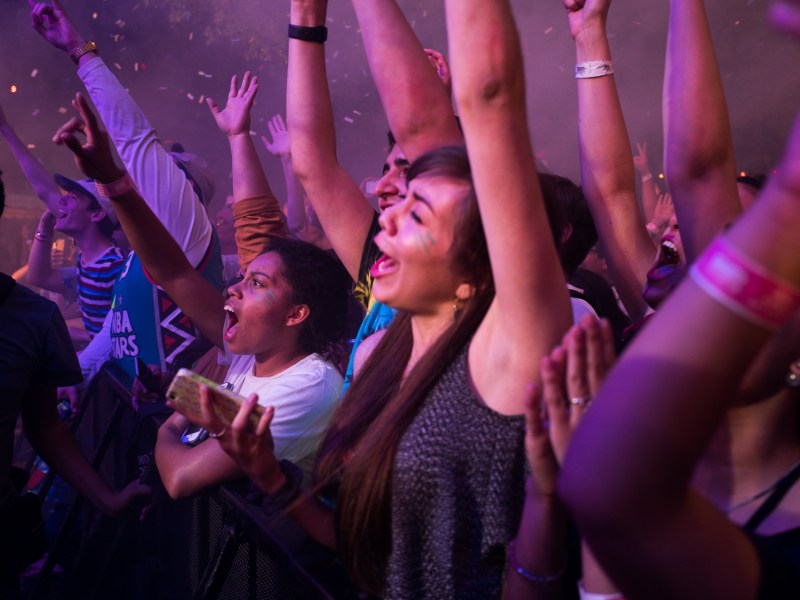 Festival goers scream as they raise their arms to The Flaming Lips song. Photo by Scott Ball.