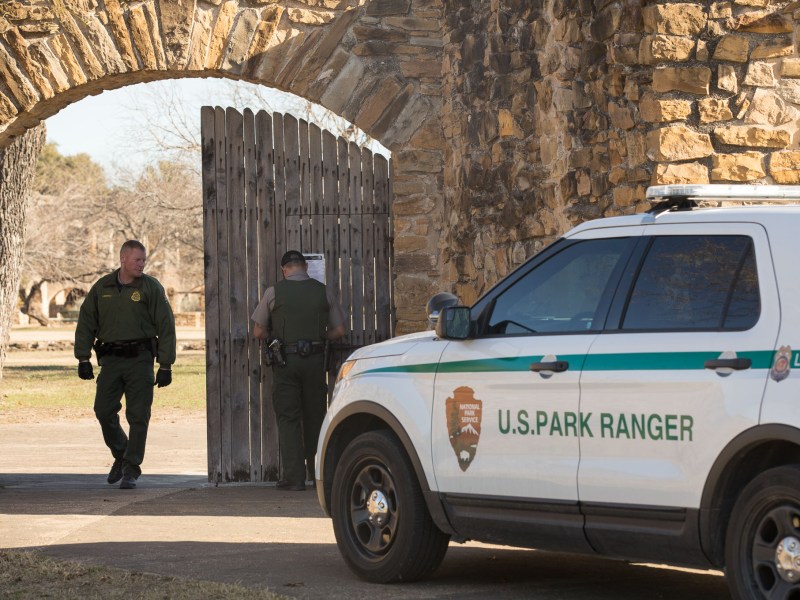 United States Park Rangers open the front gates to Mission San José.