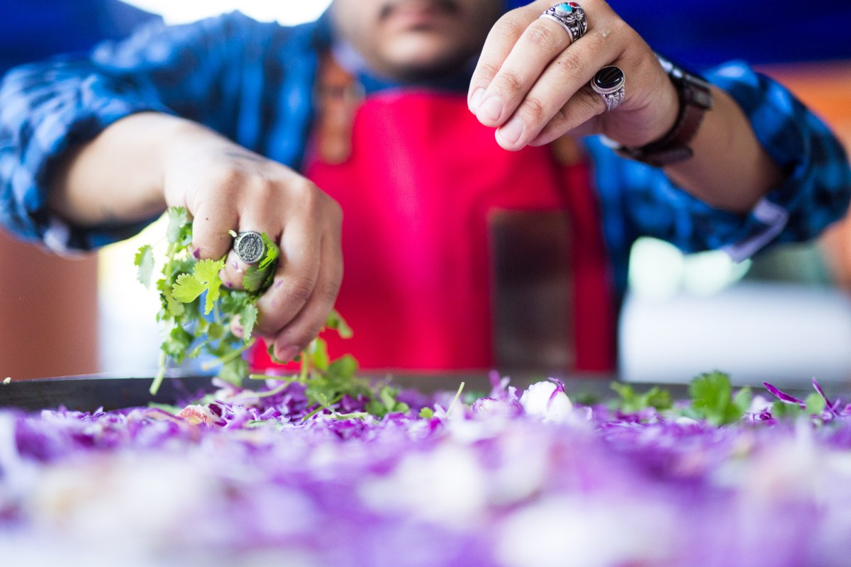 Old Main Association Chef Lorenzo Morales prepares a slaw salad. Photo by Scott Ball.