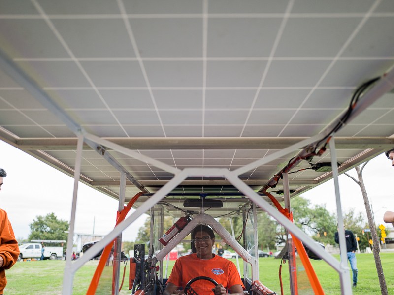 Student Jean-Luc Yohi sits in the solar powered vehicle built by Madison High School students. Photo by Scott Ball.