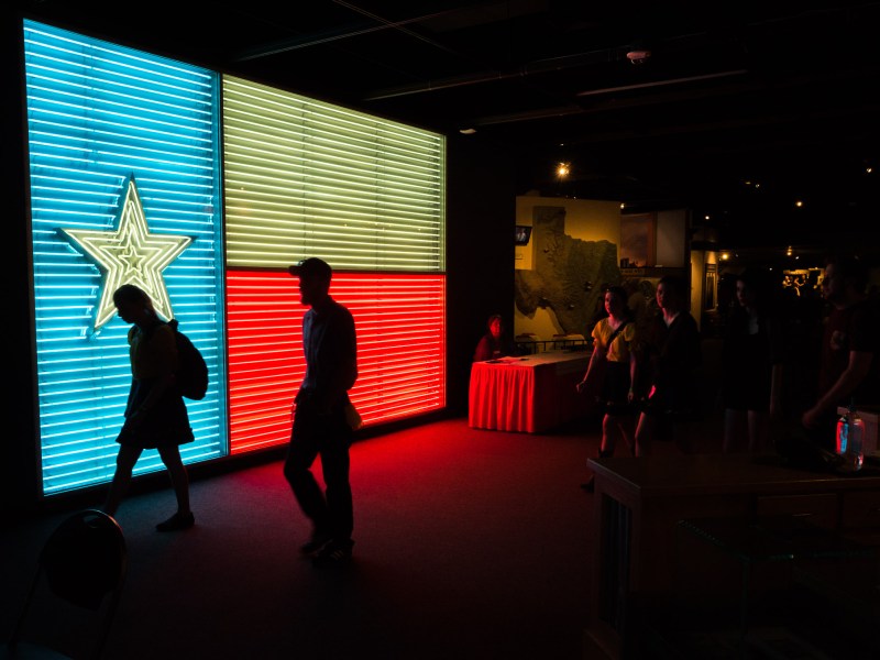 A large neon Texas Flag is displayed prominently inside the Institute of Texan Cultures. Photo by Scott Ball.