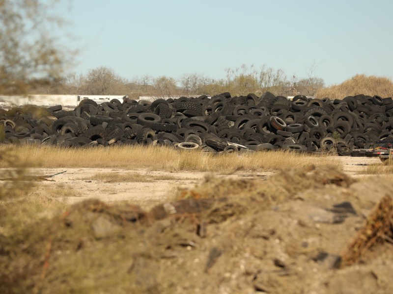 Discarded tires lay in a long strip on the 36 acre property off of Applewhite Road in the city's Southside.