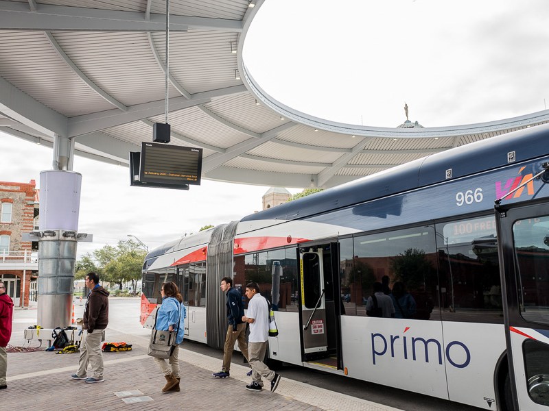 Via riders arrive at Cento Plaza. Photo by Scott Ball.