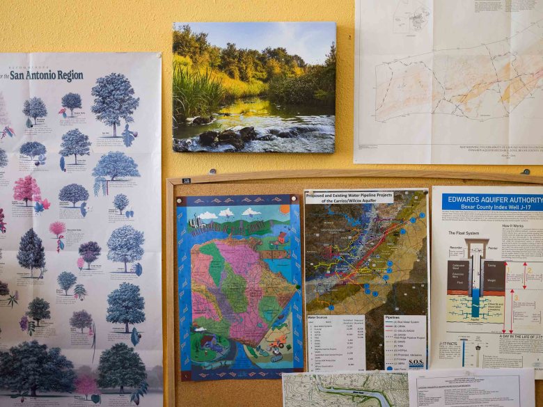 Various maps, charts and photographs are hung along the walls at the Greater Edwards Aquifer Alliance.