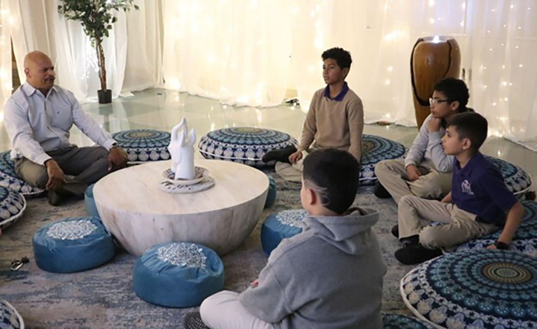 Derrick Brown, Principal of San Antonio Independent School District's Young Men's Leadership Academy, setting the tone during a student-led healing circle in November 2023.