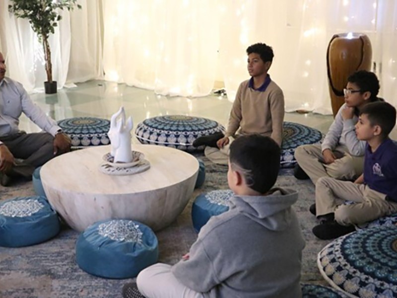 Derrick Brown, Principal of San Antonio Independent School District's Young Men's Leadership Academy, setting the tone during a student-led healing circle in November 2023.